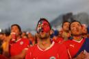 Soccer fans watch a live broadcast of the group B World Cup match between Chile and Spain, inside the FIFA Fan Fest area on Copacabana beach, in Rio de Janeiro, Brazil, Wednesday, June 18, 2014. Chile defeated Spain, the defending champs, 2-0. (AP Photo/Leo Correa)