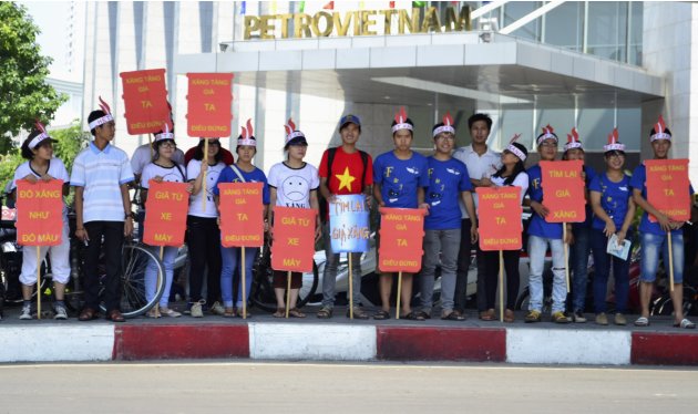 Students hold placards in front of Petro Vietnam, the national oil and gas group, during a protest in Hanoi