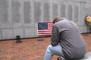 Former Marine Ed Ayers of Scranton, Penn., hangs his head and weeps at the Beirut Bombing Memorial in Jacksonville, N.C., on Wednesday, Oct. 23, 2013. Wednesday was the 30th anniversary of the terrorist bombing at a Beirut Marine barracks3 that killed 241 U.S. service members. Ayers, who did two tours in Lebanon, said the peacekeeping mission there was worth it but, "I wish it was handled differently." (AP Photo/Allen G. Breed)
