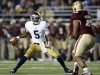 Notre Dame quarterback Everett Golson looks for an opening around Boston College Eagles defensive end Mehdi Abdesmad during the first half of an NCAA college football game in Boston on Saturday, Nov. 10, 2012. (AP Photo/Winslow Townson)