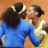 Pennetta of Italy kisses Williams of U.S. as she abandons the match following an injury during the Rome Masters tennis tournament