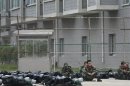 Paramilitary policemen rest in front of a workers' dormitory building inside a Foxconn Tech-Industry Park in Taiyuan