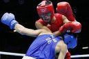 Gani Zhailauov (in red) of Kazakhstan defends against Saylom Ardee (in blue) of Thailand during their match on Sunday