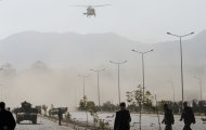 A NATO helicopter flies above the site of a suicide car bomber in Kabul, Afghanistan, Saturday, Oct. 29, 2011. A suicide car bomber struck a NATO convoy on the outskirts of Kabul on Saturday, causing casualties among the NATO service members and Afghan civilians, the U.S.-led coalition said. Afghan officials said three civilians and one policeman were killed. (AP Photo/Ahmad Jamshid)