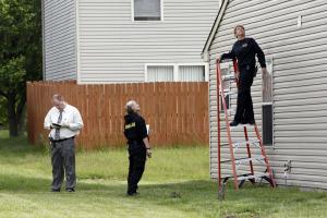 Crime lab technicians examine bullet holes in a home&nbsp;&hellip;