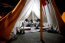 Syrians gather in a tent on September 13, 2013 at a camp in Damascus to protest against military strikes on the country