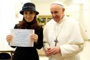In this photo provided by the Vatican newspaper L'Osservatore Romano, Pope Francis stands by Argentine President Cristina Fernandez showing a picture of a marble plaque commemorating the 1984 peace and friendship treaty between Argentina and Chile as they meet at the Pope's temporary apartments in the Santa Marta hotel at the Vatican, Monday, March 18, 2013. Inscription in Latin reads: "In the fifth year of Benedict XVI's pontificate, after 25 years from the peace and friendship treaty reached with the mediation of Pope John Paul II, Chilean President Michelle Bachelet Jeria and Argentine President Christina Fernandez de Kirchner in remembrance of the efforts, Casina Pio IV, on November 28, 2009." (AP Photo/L'Osservatore Romano)