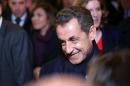 Former French President Nicolas Sarkozy leaves his headquarters, in Paris, Saturday, Nov. 29, 2014. Sarkozy had been widely expected to win the Union for a Popular Movement leadership in the vote by party members Saturday. The 59-year-old Gaullist collected 64.5 percent of the vote to defeat former government ministers Bruno Le Maire and Herve Mariton. (AP Photo/Thibault Camus)