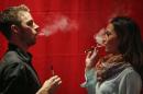 People use electronic vaporizers with cannabidiol (CBD)-rich hemp oil while attending the International Cannabis Association Convention in New York