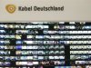 The logo of Kabel Deutschland is pictured above a monitor wall at the Kabel Deutschland playout center in Frankfurt