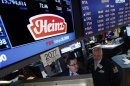 Traders work at the post that trades H.J. Heinz Co. on the floor of the New York Stock Exchange
