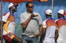 Former West Indies cricketer Courtney Walsh (C) speaks with team players during a practice session at The Wankhede Stadium in Mumbai on November 20, 2011
