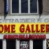 The façade of a furniture store is over the original sign for the gym where heavyweight champ Joe Frazier lived and trained, on Tuesday, April 30, 2013, in Philadelphia. The building has been named to the National Register of Historic Places.  (AP Photo/Matt Rourke)