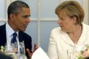 U.S. President Obama and German Chancellor Merkel chat during dinner at Chralottenburg Castle in Berlin