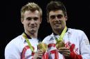 Great Britain's Jack Laugher (L) and Chris Mears (R) celebrate with their gold medal during the podium ceremony for the men's synchronised 3m springboard final on August 10, 2016