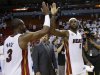 Miami Heat small forward LeBron James (6) is congratulated by  Dwyane Wade (3) after defeated the Indiana Pacers in Game 1 in their NBA basketball Eastern Conference finals playoff series, Wednesday, May 22, 2013 in Miami. The Heat won 103-102 in overtime. (AP Photo/Lynne Sladky)