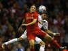 Liverpool's Downing challenges Hearts' Paterson during their Europa League soccer match at Anfield in Liverpool