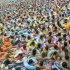 File photo showing residents crowding in a swimming pool to escape the summer heat during a hot weather spell in Daying county of Suining