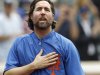 New York Mets starting pitcher R.A. Dickey puts his hand to his heart as the thanks the fans as he celebrates his 20th victory of the season after the Mets 6-5 win against the Pittsburgh Pirates in a baseball game at Citi Field in New York, Thursday, Sept. 27, 2012. (AP Photo/Kathy Willens)