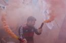A supporter of ruling party presidential candidate Daniel Scioli holds a couple of flares during a closing campaign rally in La Matanza, in the outskirts of Buenos Aires, Argentina, Thursday, Nov. 19, 2015. Scioli will face opposition candidate Mauricio Macri in a Nov. 22 runoff. (AP Photo/Ricardo Mazalan)