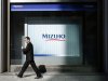 A man walks past a branch of Mizuho bank belonging to Mizuho Financial Group in Tokyo