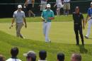 Defending U.S. Open Champion Jordan Spieth, center, walks up the 17th fairway with Rory McIlroy, left, of Northern Ireland, and Rickie Fowler during a practice round for the 2016 US Open golf championship at Oakmont Country Club in Oakmont, Pa., Monday, June 13, 2016. (AP Photo/Gene J. Puskar)