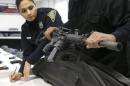 A New Haven police officer catalogues a Bushmaster semi-automatic assault rifle that is turned in during a gun buyback event in New Haven