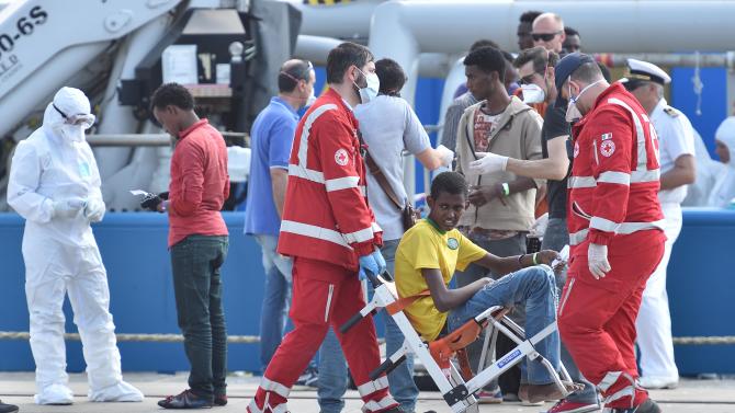 A migrants receives medical care after he was disembark from the Swedish Coast Guard ship KBV 001 Poseidon at Messina harbor, Italy, Tuesday, June 9, 2015. Over the last weekend, nearly 6,000 migrants were rescued by an array of European military vessels, including 2,371 who were saved on Sunday from 15 boats that ran into difficulty shortly after smugglers set off with them from Libyan shores, the Italian coast guard said. (AP Photo/Carmelo Imbesi)