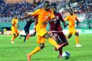 Equatorial Guinea's player Armando Sipoto Bonale (L) vies with Ivory Coast's Jean Daniel Akpa Akpro during the friendly football match on March 29, 2015 in Abidjan