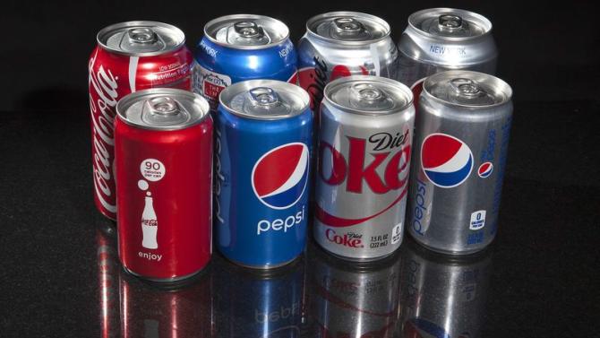 Regular and mini cans of Coke and Pepsi are pictured in this photo illustration in New York