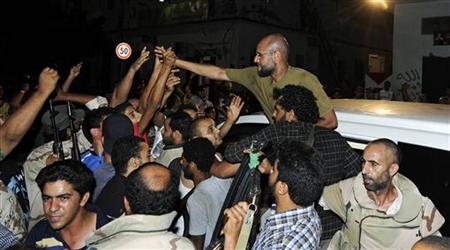 Saif Al-Islam, son of Muammar Gaddafi, greets supporters in Tripoli