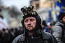 A protestor part of the "Self Defence of Maidan" and wearing an optic device on his head guards the Ukrainian parliament on February 27, 2014 in Kiev