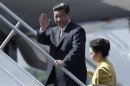China's President Xi waves next to his wife Peng before their departure to Mexico at Juan Santamaria Airport in Alajuela