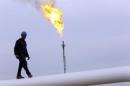 A worker walks on an oil pipeline at Khurmala oilfield on the outskirts of the city of Arbil, in Iraq's Kurdistan region