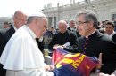 In this photo provided by the Vatican paper L'Osservatore Romano and made available Thursday, April 18, 2013, Mons. Miguel Delgado Galindo presents a jersey of Argentine soccer star Lionel Messi to Pope Francis, at the Vatican Wednesday, April 17, 2013. (AP Photo/L'Osservatore Romano, ho)