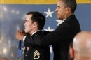 U.S. President Barack Obama awards the Medal of Honor to former active duty Army Staff Segeant Clinton Romesha during a ceremony in the East Room of the White House in Washington