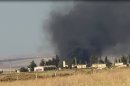 This citizen journalism image provided by Edlib News Network, ENN, which has been authenticated based on its contents and other AP reporting, shows black smoke rising from what rebels say is a helicopter that was shot down at Abu Dhour military airbase which is besieged by the rebels, in the northern province city of Idlib, Syria, Friday May 17, 2013. Rights activists have found torture devices and other evidence of abuse in government prisons in the first Syrian city to fall to the rebels, Human Rights Watch said in a report Friday. (AP Photo/Edlib News Network ENN)