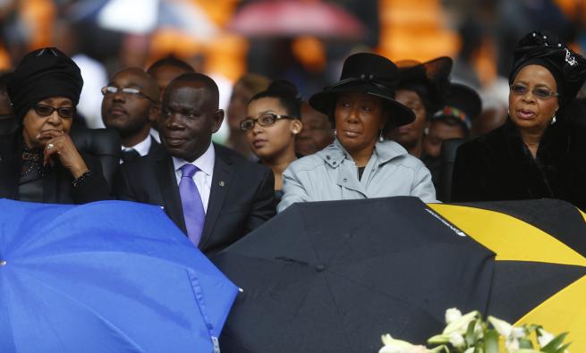 Late South African President Nelson Mandela&#39;s ex-wife Winnie and wife Graca Machael attend the official memorial service for Mandela in Johannesburg