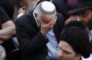 An Israeli mourns during the funeral of Kopinsky, Levine and Goldberg in Jerusalem