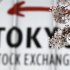 The logo of the Tokyo Stock Exchange is seen as cherry blossoms in full bloom in Tokyo