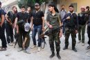Free Syrian Army fighters prepare to head out to the frontline in Damascus on May 5.