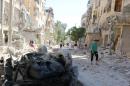 People inspect the damage at a site hit overnight by an air strike in the rebel-held area of Seif al-Dawla neighbourhood of Aleppo
