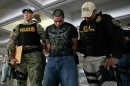 Drug Enforcement Administration officers escort a handcuffed suspect after his arrest on drug smuggling charges in San Juan, Puerto Rico, Wednesday, June 6, 2012. U.S. federal agents say they raided Puerto Rico's international airport and other areas early Wednesday, arresting at least 33 people suspected of smuggling millions of dollars' worth of drugs aboard commercial flights. (AP Photo/Ricardo Arduengo)