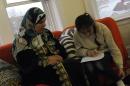 Syrian refugee Safa Mshymish sits with her daughter Rama in their apartment in Chicago, Illinois
