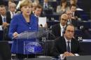 German Chancellor Angela Merkel addresses the European Parliament as French President Francois Hollande listens during a debate in Strasbourg
