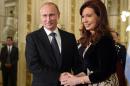 Russian President Vladimir Putin, left, shakes hands with Argentina's President Cristina Fernandez at Government Palace during a one-day visit, in Buenos Aires, Argentina, Saturday, July 12, 2014. Putin's next stop is Brazil for a presidential summit of the BRICS group of nations in Fortaleza. He was also to attend the final World Cup match in a ceremonial handover of host duties for soccer's marquee tournament, which takes place in Russia in 2018. (AP Photo/RIA-Novosti, Alexei Nikolsky, Presidential Press Service)