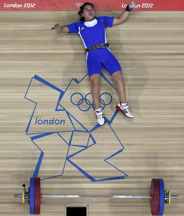 Philippines's Hidilyn Diaz falls backwards after failing to lift on the women's 58Kg Group B weightlifting competition at the London 2012 Olympic Games