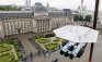 Guests enjoy a "dinner in the sky" on a platform hanging in front of the Royal Palace in Brussels