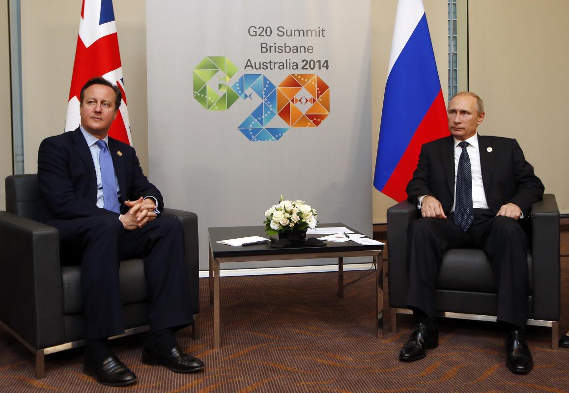 British Prime Minister Cameron sits with Russian President Putin during their bilateral meeting on the side of the G20 leaders summit in Brisbane