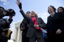 Plaintiff Edith Windsor,of New York, waves to supporters in front of the Supreme Court in Washington, Wednesday, March 27, 2013, after the court heard arguments on her Defense of Marriage Act (DOMA) case. The U.S. Supreme Court, in the second day of gay marriage cases, turned Wednesday to a constitutional challenge to the federal law that prevents legally married gay Americans from collecting federal benefits generally available to straight married couples. (AP Photo/Carolyn Kaster)
